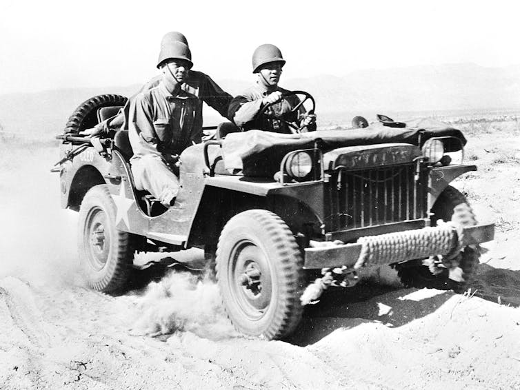 black and white photo of soldiers in small 4WD