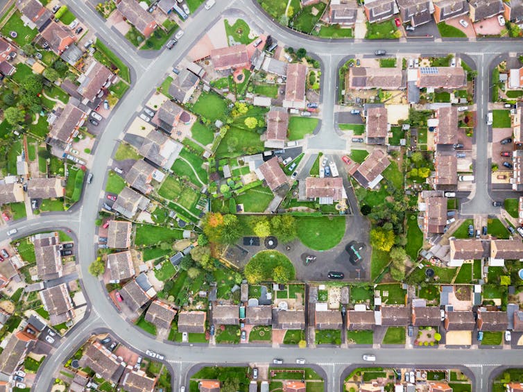 An aerial view of residential houses and gardens