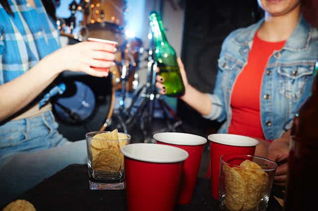 Two people share drinks at a party.