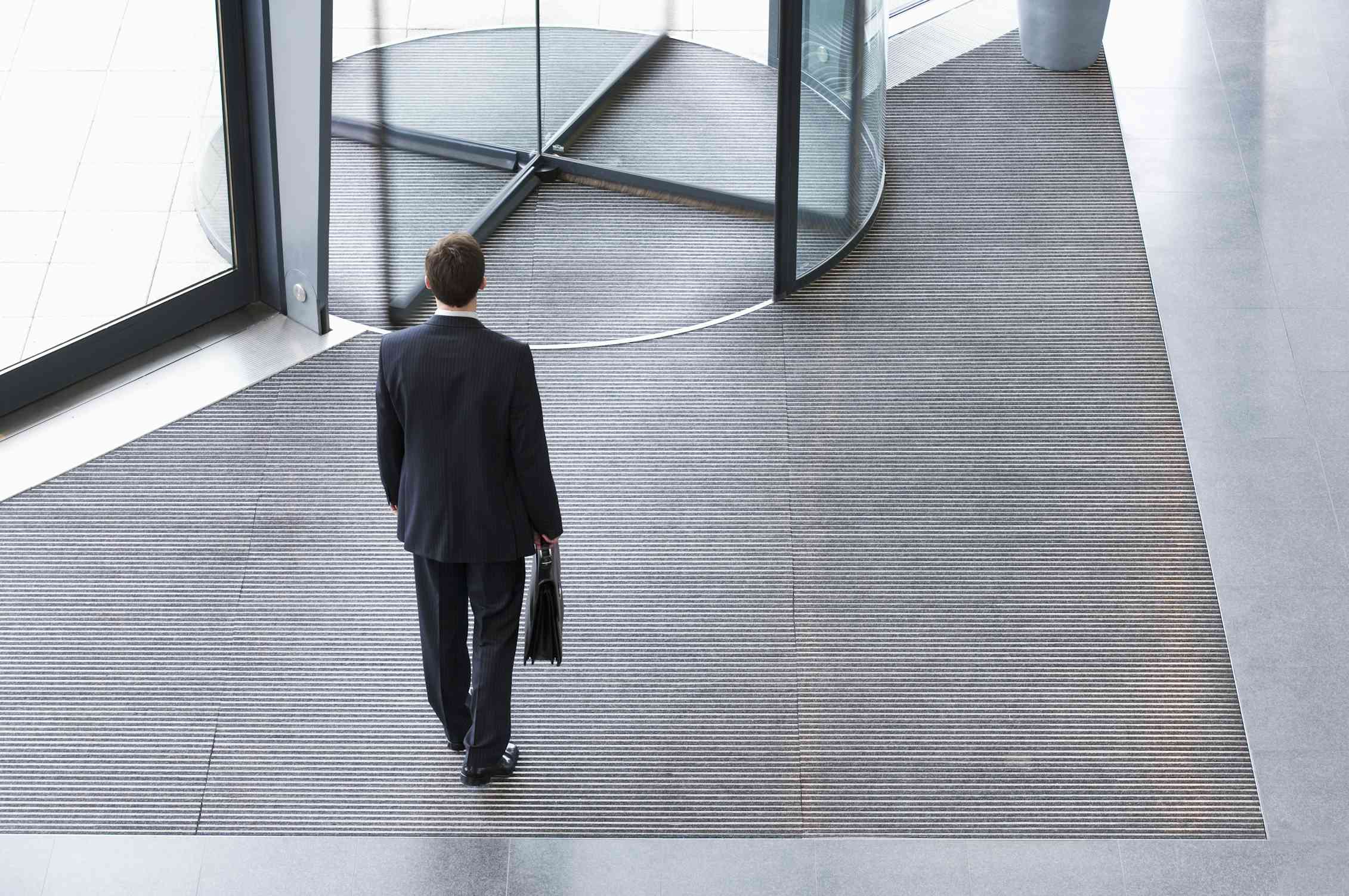 man entering revolving door