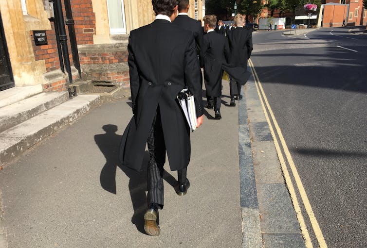 Eton school pupils walking in street