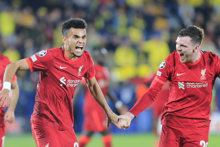 Two Liverpool players celebrate a goal.