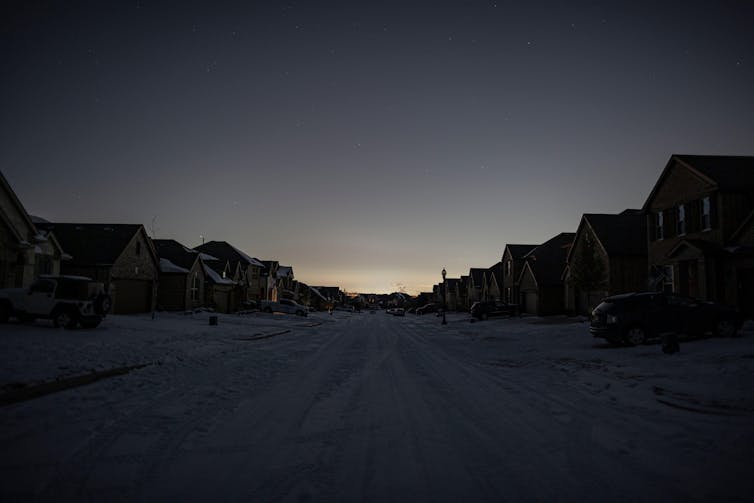 Dawn on a snowy US street without power.