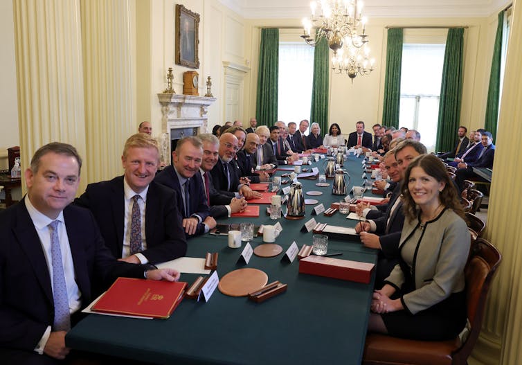 Members of Boris Johnson's cabinet sit around the cabinet table.