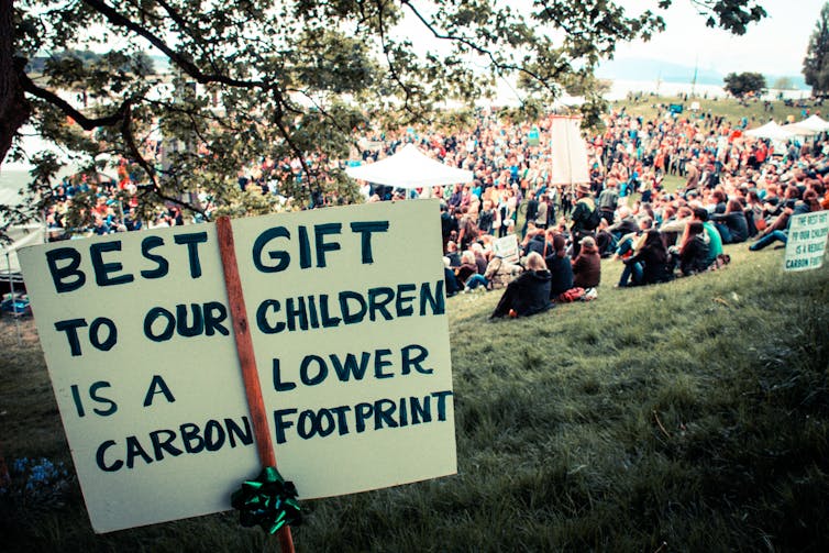A sign reading 'Best gift to our children is a lower carbon footprint'