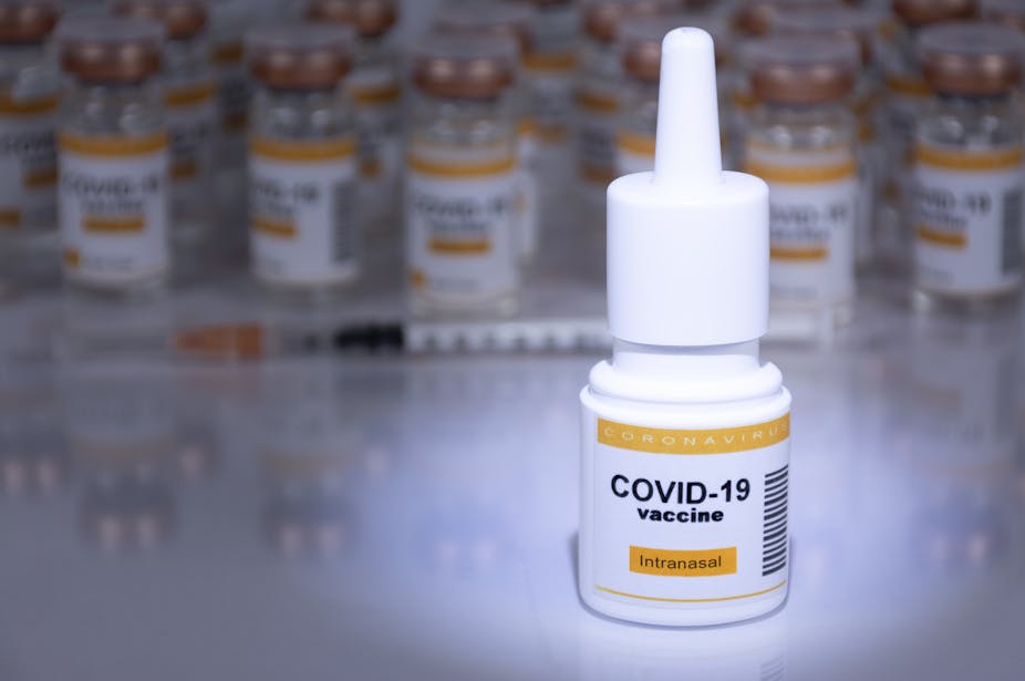 A nasal spray bottle with a label saying 'COVID-19 vaccine'.