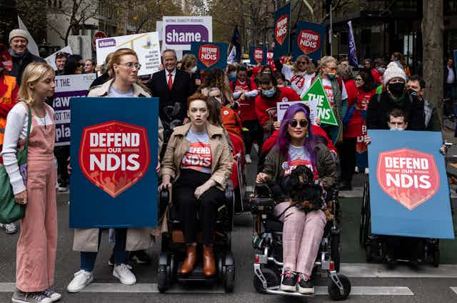Large crowd protest in street to protect NDIS