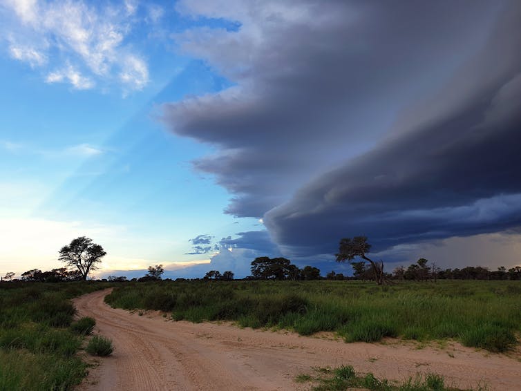 Heavy cloud cover moving across some land.