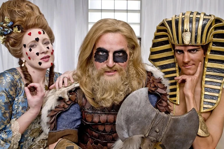 Three people dressed as historical figures.