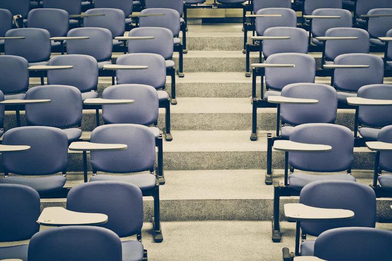 Rows of chairs seen in a university lecture hall