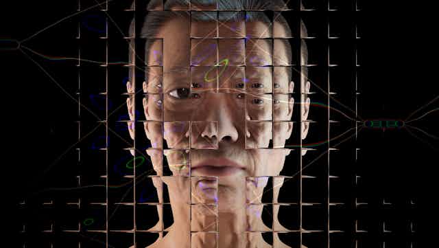 A photo of a woman's face refracted through a grid of glass squares.