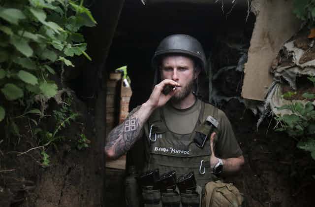 A Ukrainian soldier smokes a cigarette in his defensive position in the DOnbas, eastern Ukraine.