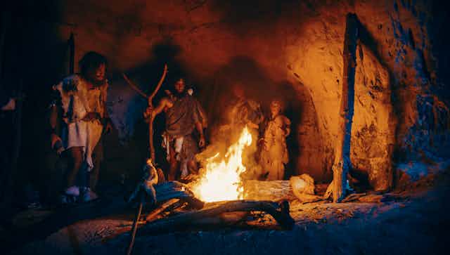Group of Stone Age people around fire