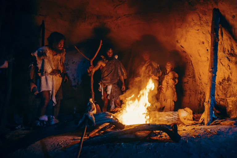 Group of Stone Age people around fire