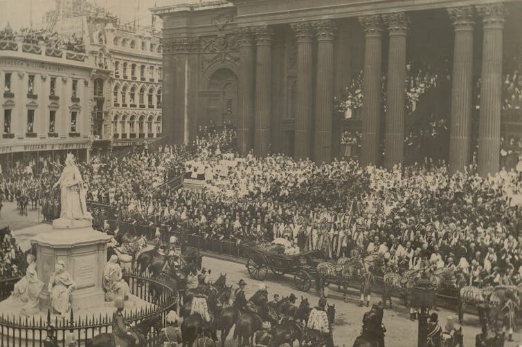 A huge processions of people outside of a cathedral.