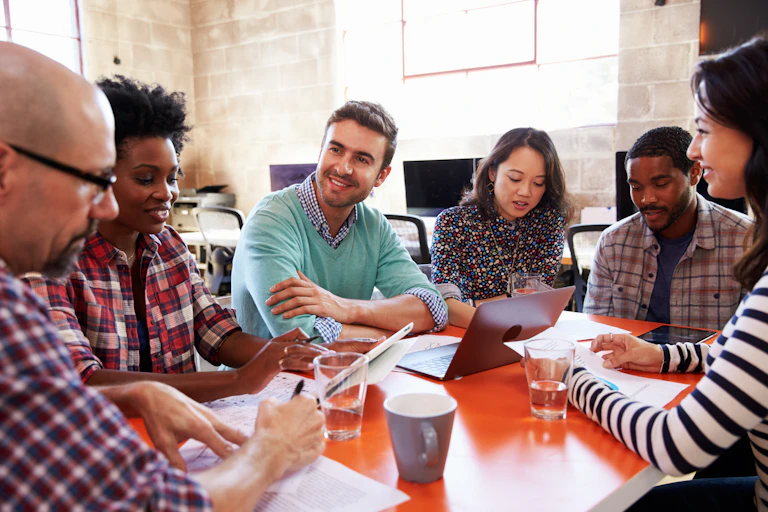 A group of people discucssing a project.