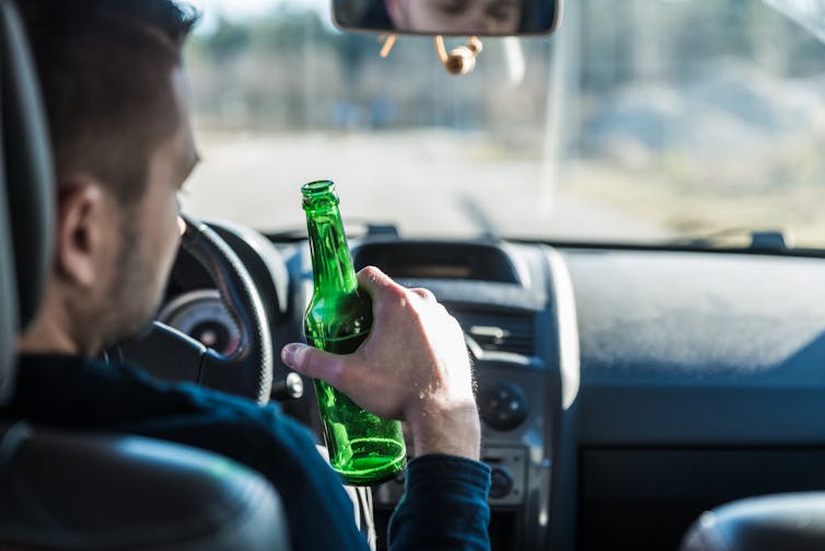 Man drinking beer while driving.