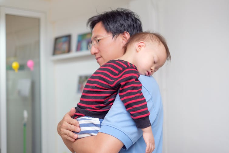 Dad holding sleeping baby