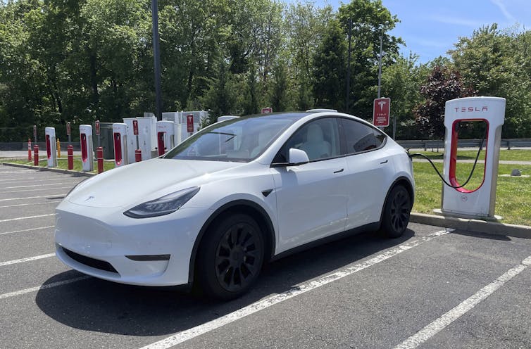 An electric car charging at a Tesla station