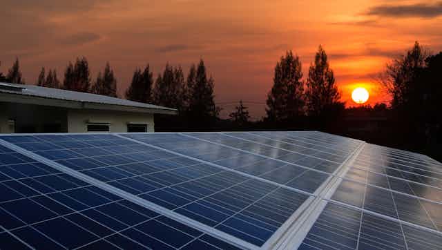 Sunset over rooftop solar panels