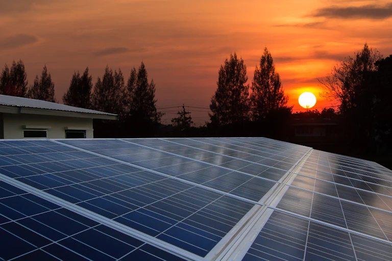 Sunset over rooftop solar panels