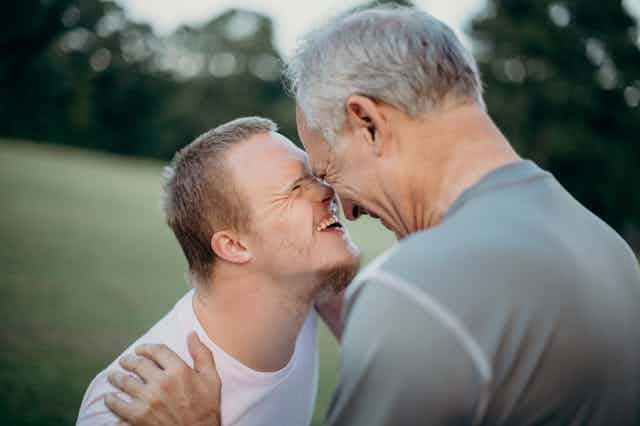 younger man and older man touch noses