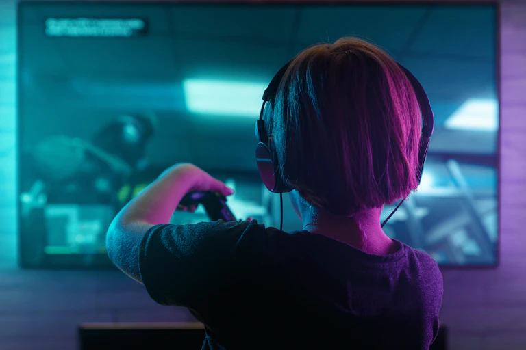 Boy seen from back playing video game