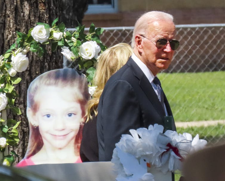 US president Joe Biden walks through a memorial to the children killed in the May 2022 Uvalde school shooting in Texas, including a picture of one of the victims.