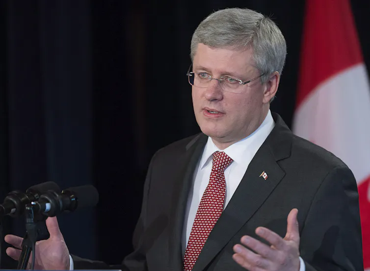 A man in a suit gesturing while he speaks