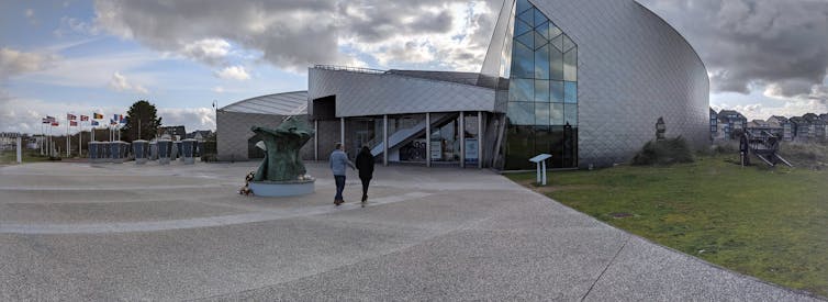 People walk up to a modern building