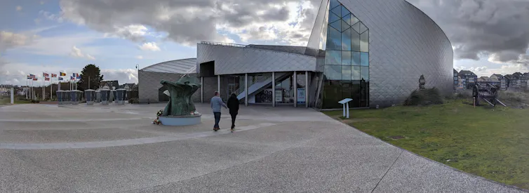 People walk up to a modern building