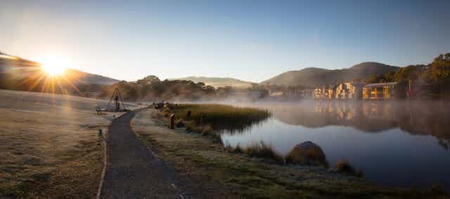 The sun rises over Lake Crackenback on a cold morning in New South Wales.