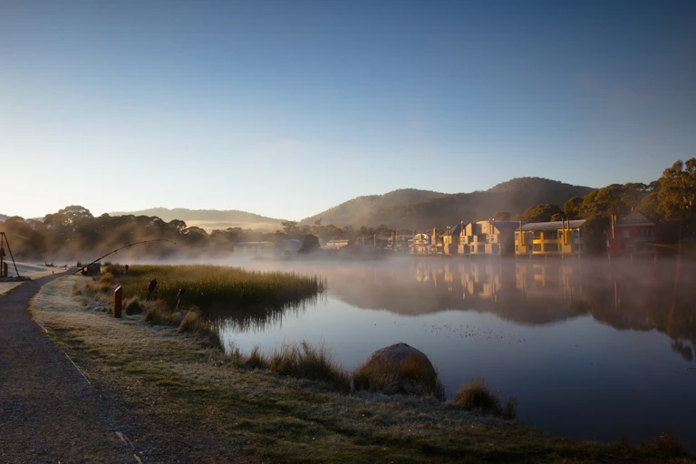 The sun rises over Lake Crackenback on a cold morning in New South Wales.