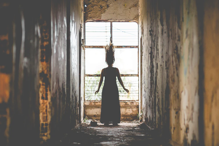 Spooky silhouette stands in dilapidated hallway