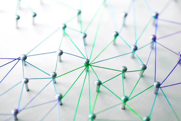 Pins on a board, connected with string