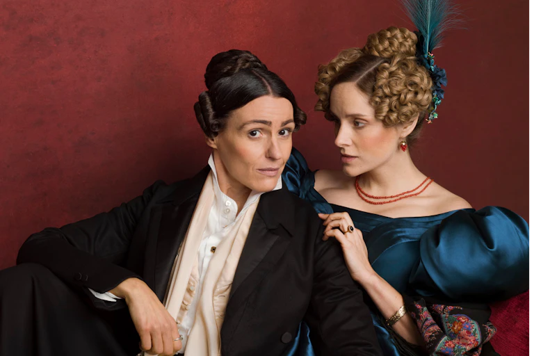 Two women in period dress.