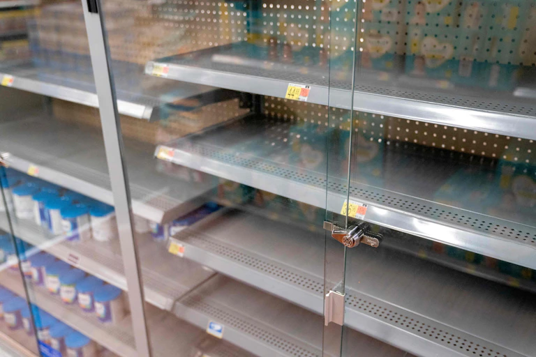 Rows of empty shelves at a grocery store.