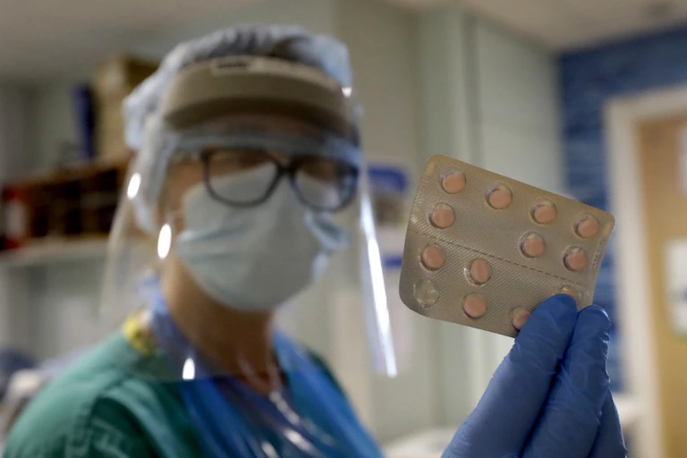 A nurse prepares medication for a patient in the TACTIC-R clinical trial at Addenbrooke's Hospital in Cambridge, England, May 21, 2020.