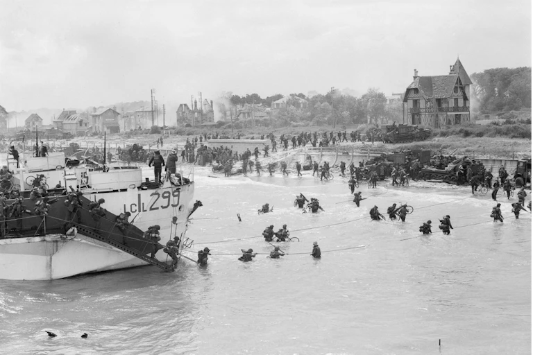 Soldiers walk through the water to shore