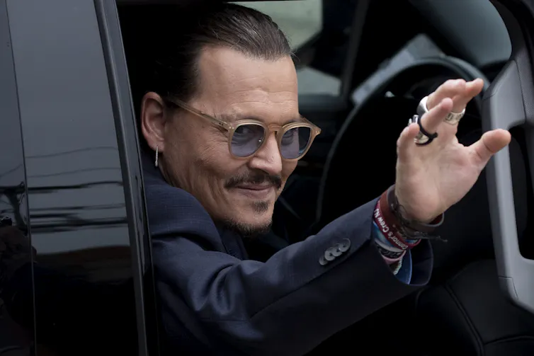Johnny Depp waving out of a car