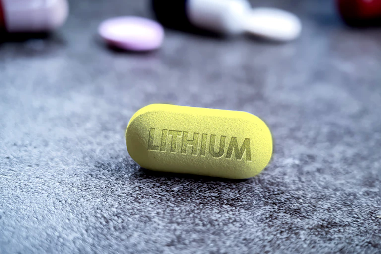 Une pilule marquée lithium est posée sur un fond gris