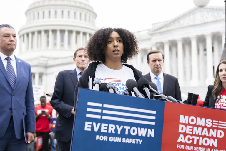 A woman speaks in favor of gun control in front of the U.S. Capitol building