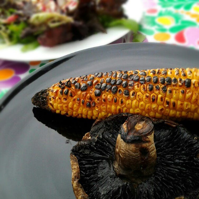 A piece of corn and a large mushroom showing blackened spots.