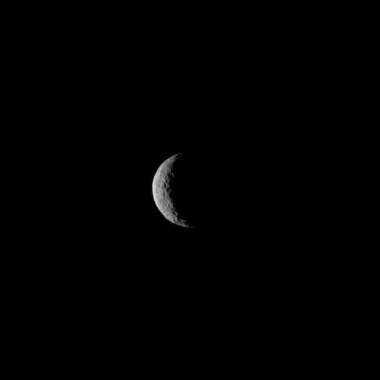 A black and white photograph of Ceres, which looks like an eclipsed moon