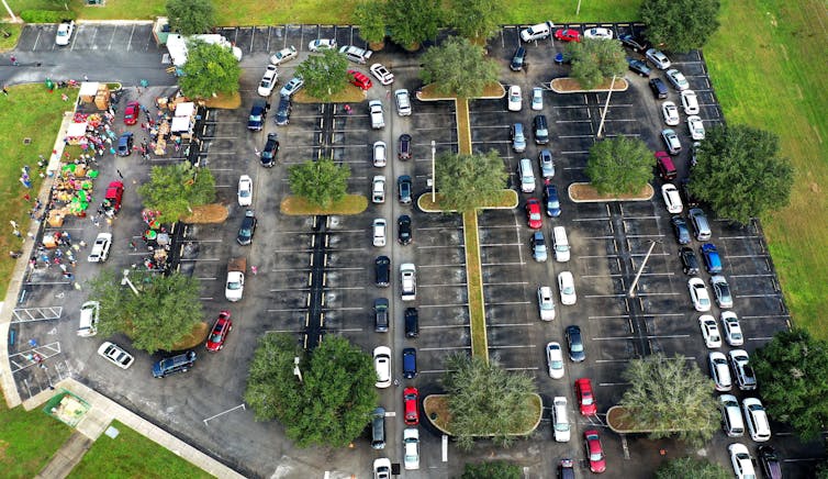A long line of cars wraps around a parking lot