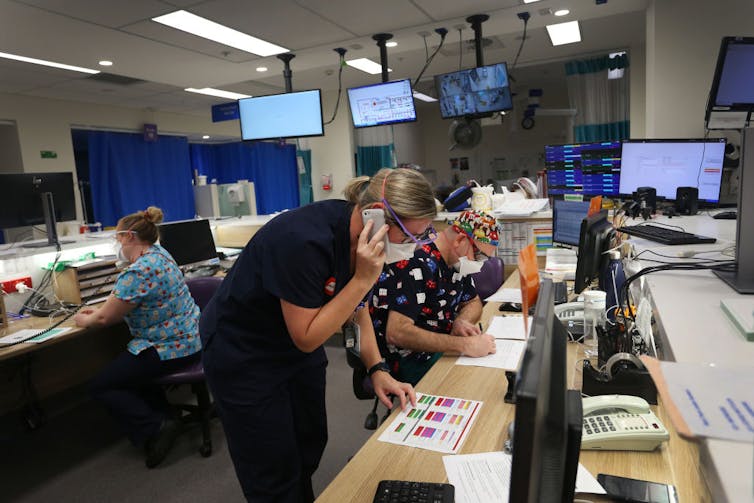 hospital staff at busy work station