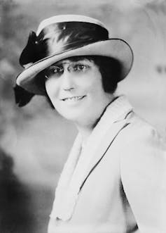 A black-and-white portrait of a woman from the 1920s.