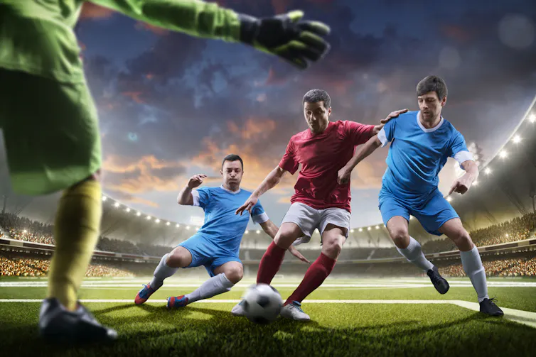 4 hommes jouant au soccer