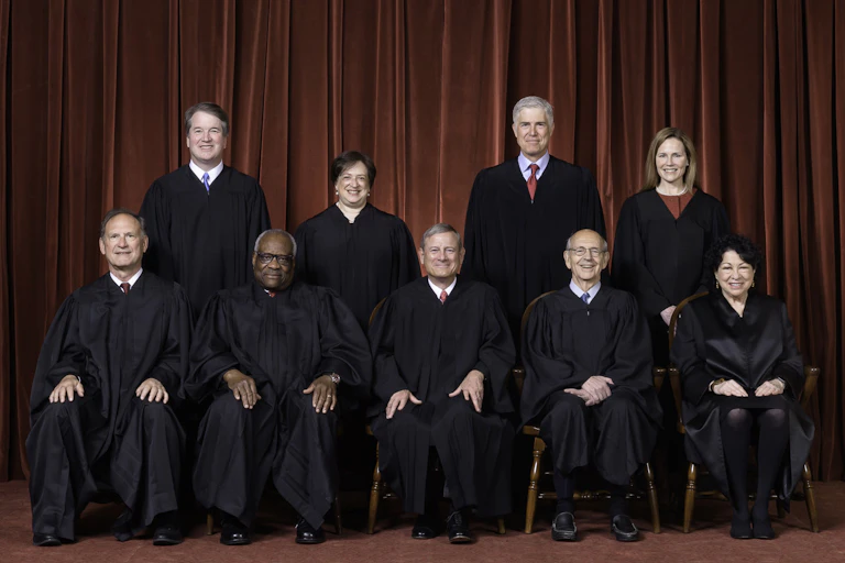 A group of nine people wearing black robes