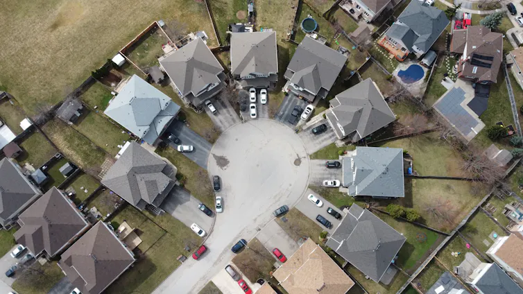 An aerial view of residential neighbourhood with minimal tree cover.